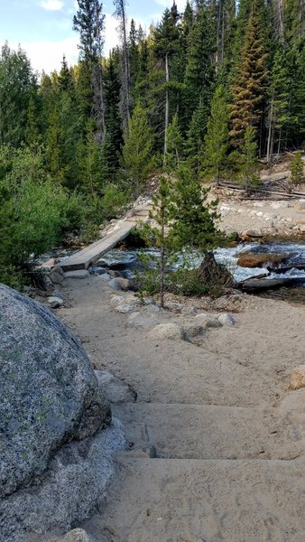 The bridge across Roaring River has been rebuilt, providing easy access to the Ypsilon Trail.