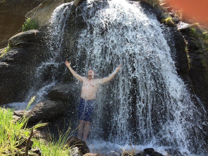 Soak in the warm shower overflow from the Three Forks Hot Springs.