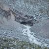 Carbon Glacier melt flows down the nearby rocky slopes.