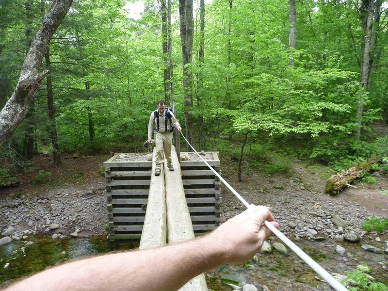 A neat river crossing with a rope railing for balance.