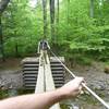 A neat river crossing with a rope railing for balance.
