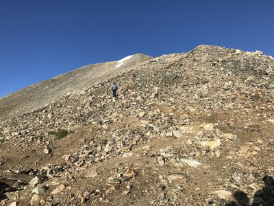 Starting the switchbacking climb to the top of Democrat on small boulders with tricky footing.