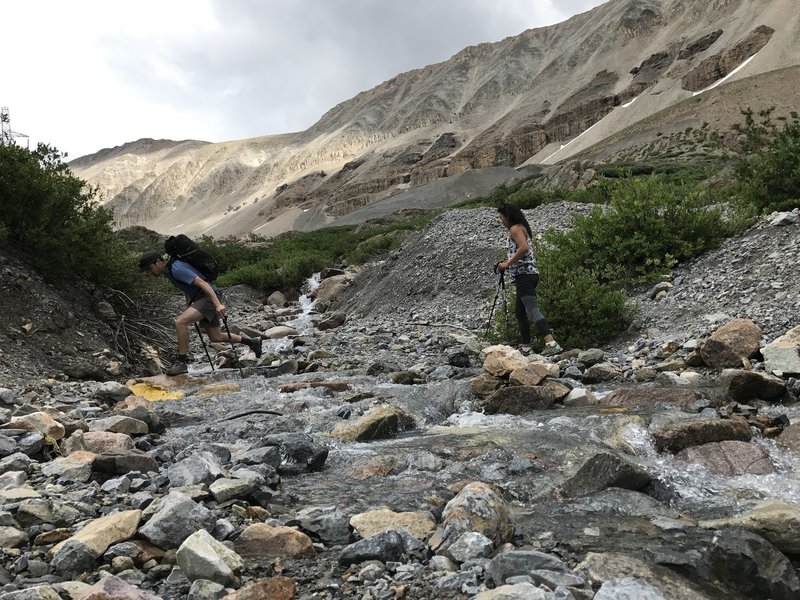 The major creek crossing in Iowa Gulch. Helps to have poles but there are good rocks to walk across.