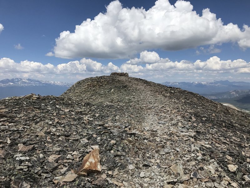 The short saddle at the top of Mount Sheridan with the windbreak at the end.