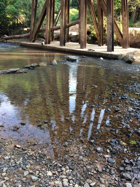 Small stream crossing that you get to rock hop across under train trestle.