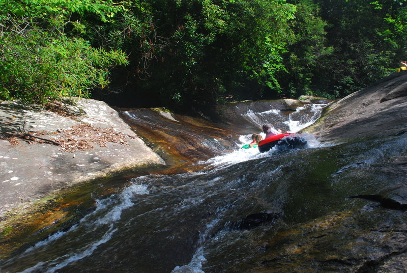 Tubers coming down the longer natural waterslide near Upper Creek Falls.