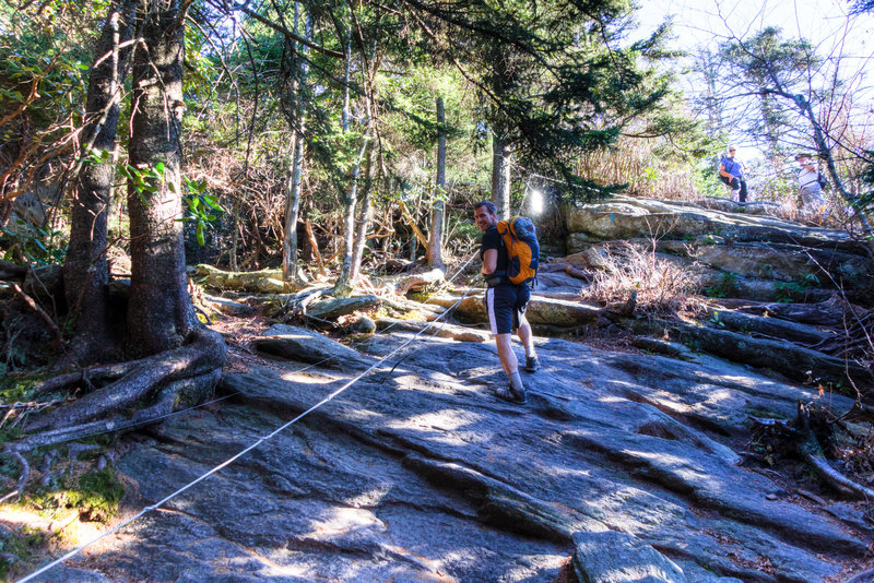 Using the anchored cables on the Grandfather Trail.