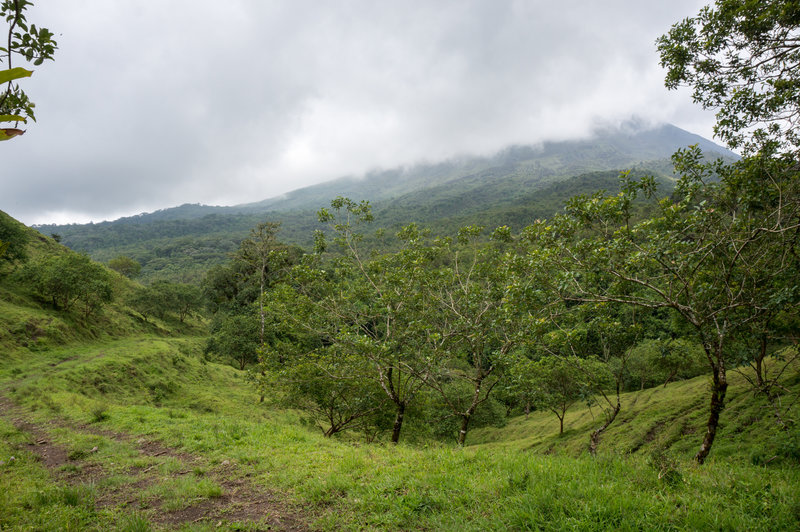 Arenal Volcano shrouded in low clouds.