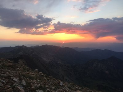 A red sunrise over the Wasatch Mountains from the ridge up toward American Fork Twin peaks