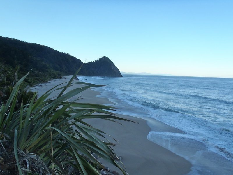 Early morning light on the sea looking back to Kohaihai Bluff at the south end of the Heaphy Track.