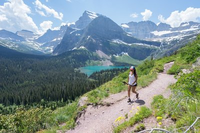 Hiking Grinnell Glacier Trail with Grinnell Lake in the background.