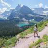 Hiking Grinnell Glacier Trail with Grinnell Lake in the background.