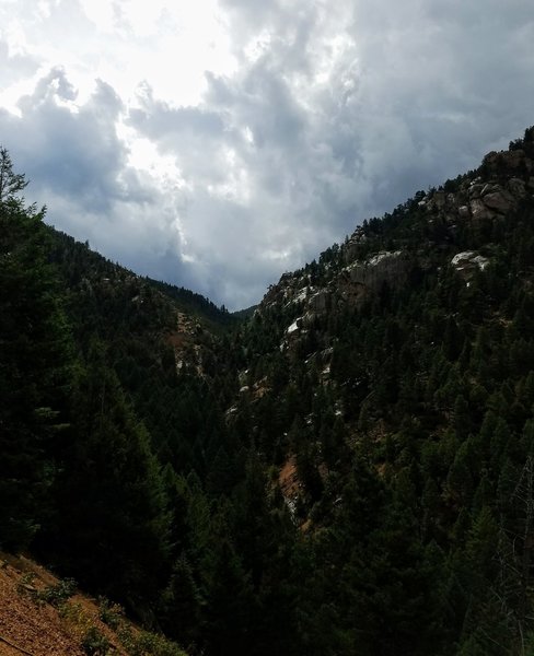 Beautiful view of waterfall and rocky terrain glistening after rainfall.