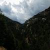 Beautiful view of waterfall and rocky terrain glistening after rainfall.