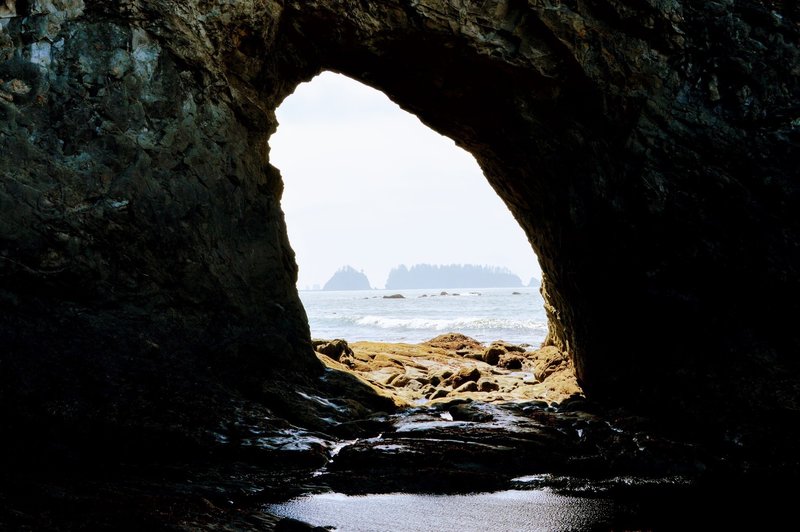 Checking out some sea stacks through hole-in-the-wall.