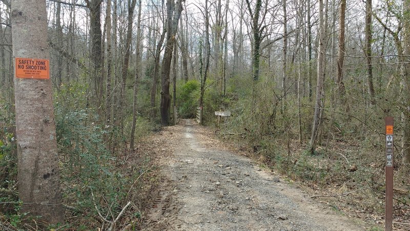 The trail entrance from Butch Kennedy Trailhead is found down the hill from the parking area. Difficult to see from parking area.