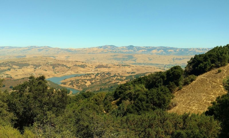 Calero Reservoir with the Santa Teresa Hills behind it, and the Diablo Range in the distance, looking northeast from high on Bald Peaks Trail