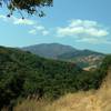 Loma Prieta in the Santa Cruz Mountains, appears in the distance, upon rounding a bend, high on Little Llagas Creek Trail.