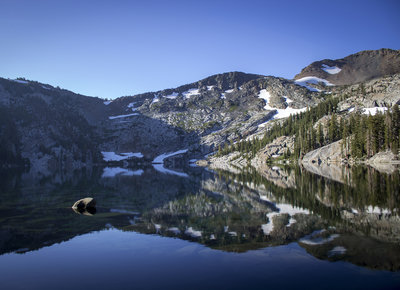 Dicks Lake, early morning. The reflective waters were aided by clear skies and still conditions. Dicks Peak squeezes in on the top right, to the North of Dicks Pass.