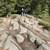 Climbing brief stretches of granite outcrops with trekking poles on Beech Cliff Loop Trail