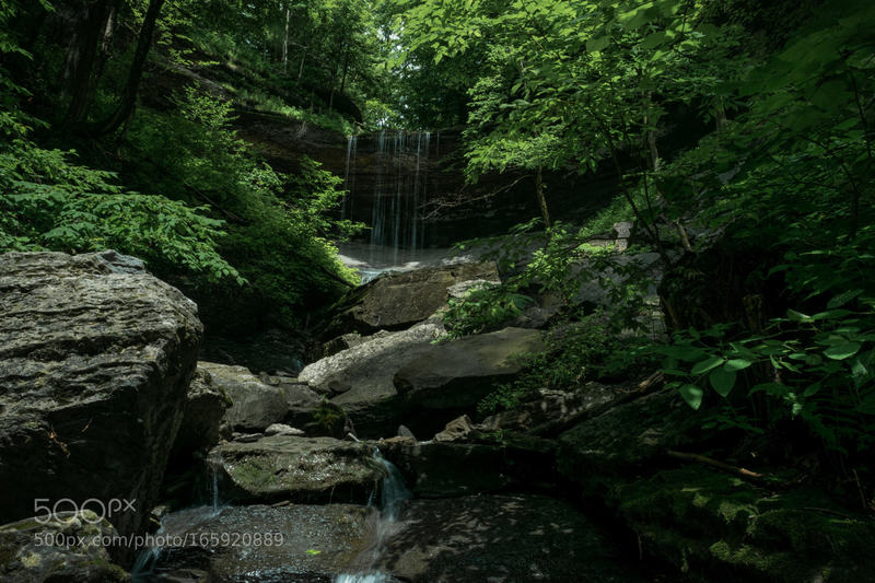 After a light summer rain, water dribbles over Tinker Falls in Truxton, NY.