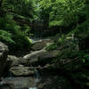 After a light summer rain, water dribbles over Tinker Falls in Truxton, NY.