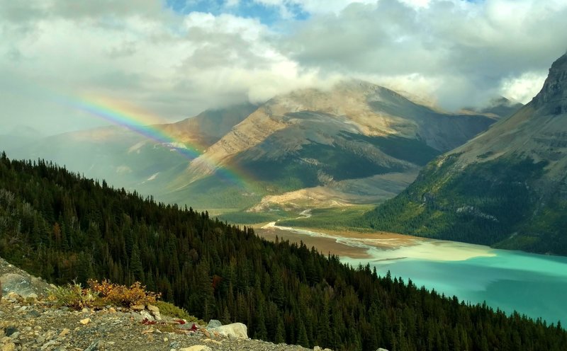 Rainbow over the valley of Berg Lake Trail. Berg Lake (front left), shoulder of Rearguard Mountain (left), and Tatei Ridge in the distance (center). Looking east from the Hargreaves Lake and Glacier Viewpoint.