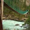 Crossing the swift flowing Robson River on a suspension bridge near the Whitehorn trail camp