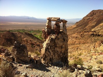 The big cairn overlooking the golf course at the summit saddle.