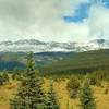 Snowy Calumet Ridge is in the distance, as the Moose River Route heads north across meadows dotted with firs.