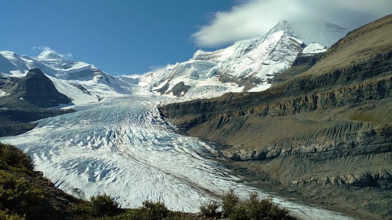 Robson Glacier flows down from Mt. Robson (right). Resplendent Mountain is in the distance on the left. Looking ahead (east-southeast) on Snowbird Pass Route.