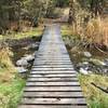 Bridge crossing creek at trail convergence area.