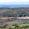 The summit of Brace Mountain offers a colorful view of the Hudson Valley with the Catskill Mountains far in the background