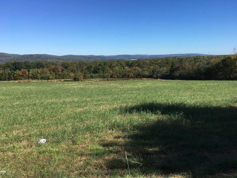 View northeast across fields, of surrounding mountains with Spruce Run Reservoir in the distance.