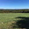 View northeast across fields, of surrounding mountains with Spruce Run Reservoir in the distance.