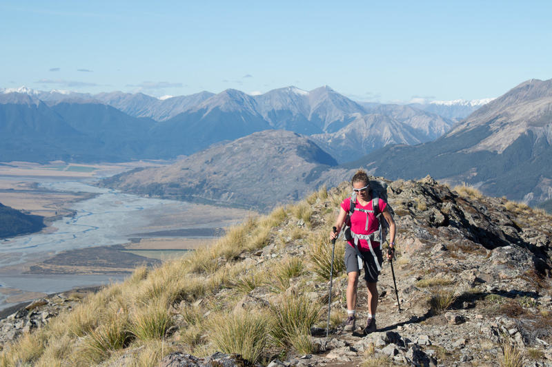 Hiking up Bealey Spur with the Waimakariri River Valley in the background.