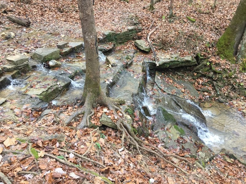 Base of Tioga falls and hand built wagon road bed is visible