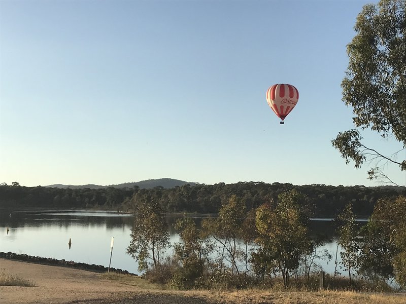 Early morning, balloon floating over Crusoe Reservoir.