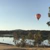 Early morning, balloon floating over Crusoe Reservoir.