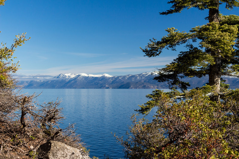 Snow covered mountains across Lake Tahoe from Rubicon Trail in D.L. Bliss State Park