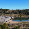 Reflections in the pools formed around the limestone slabs of Pedernales Falls