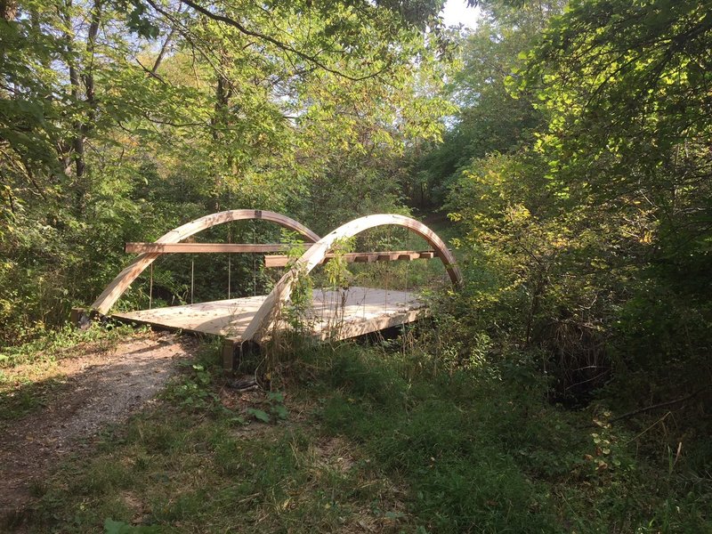 Footbridge with arches along the northeast to northwest trail in Hickory Hill Park.