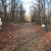 The singletrack leading the to carpark is off to the right through a gap in the fence.