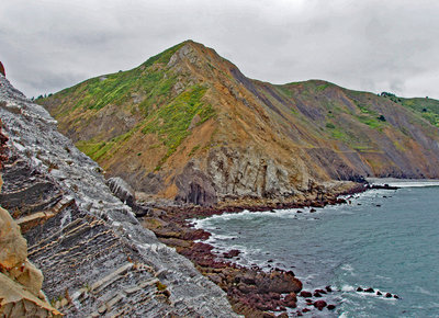 Looking towards Pedro Point Headlands. The grade line for a train that went around the headlands is still visible. The route was quickly abandoned because the land is too unstable to be maintained.