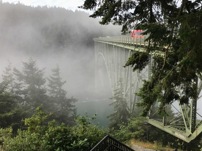 Fog swallowing Deception Pass Bridge.