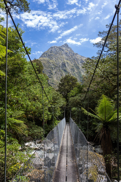 Bridge across Roaring Burn to reach Quintin Lodge. The Twin Sisters are up ahead.