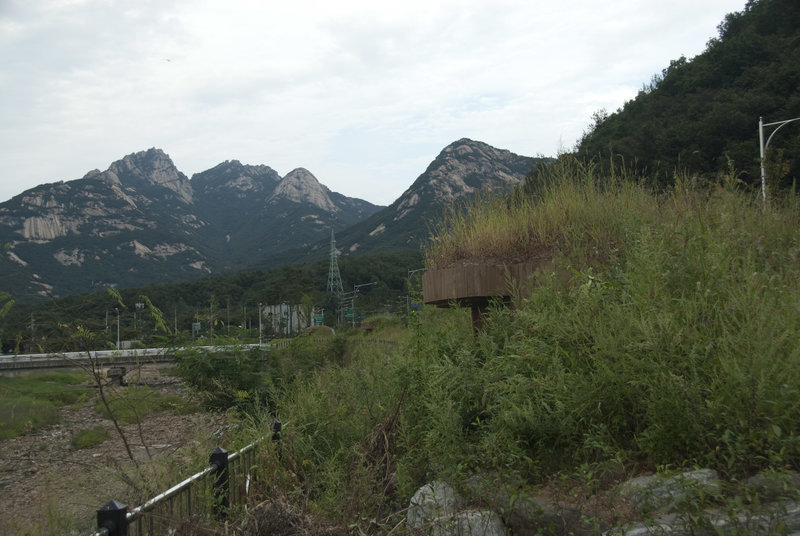 Bunker integrated into the park's landscaping with Bukhansan in the distance