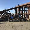 A group poses on the wreck.