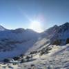 View from Peak 2 looking southeast. Powerline Pass is just below the sun and Ptarmigan Peak is the first peak to the right of the sun.