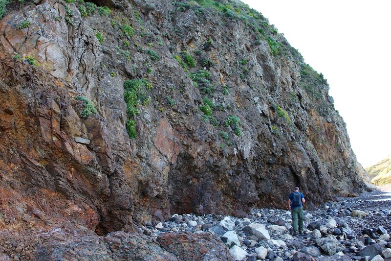 In front of the shoreline cliff.